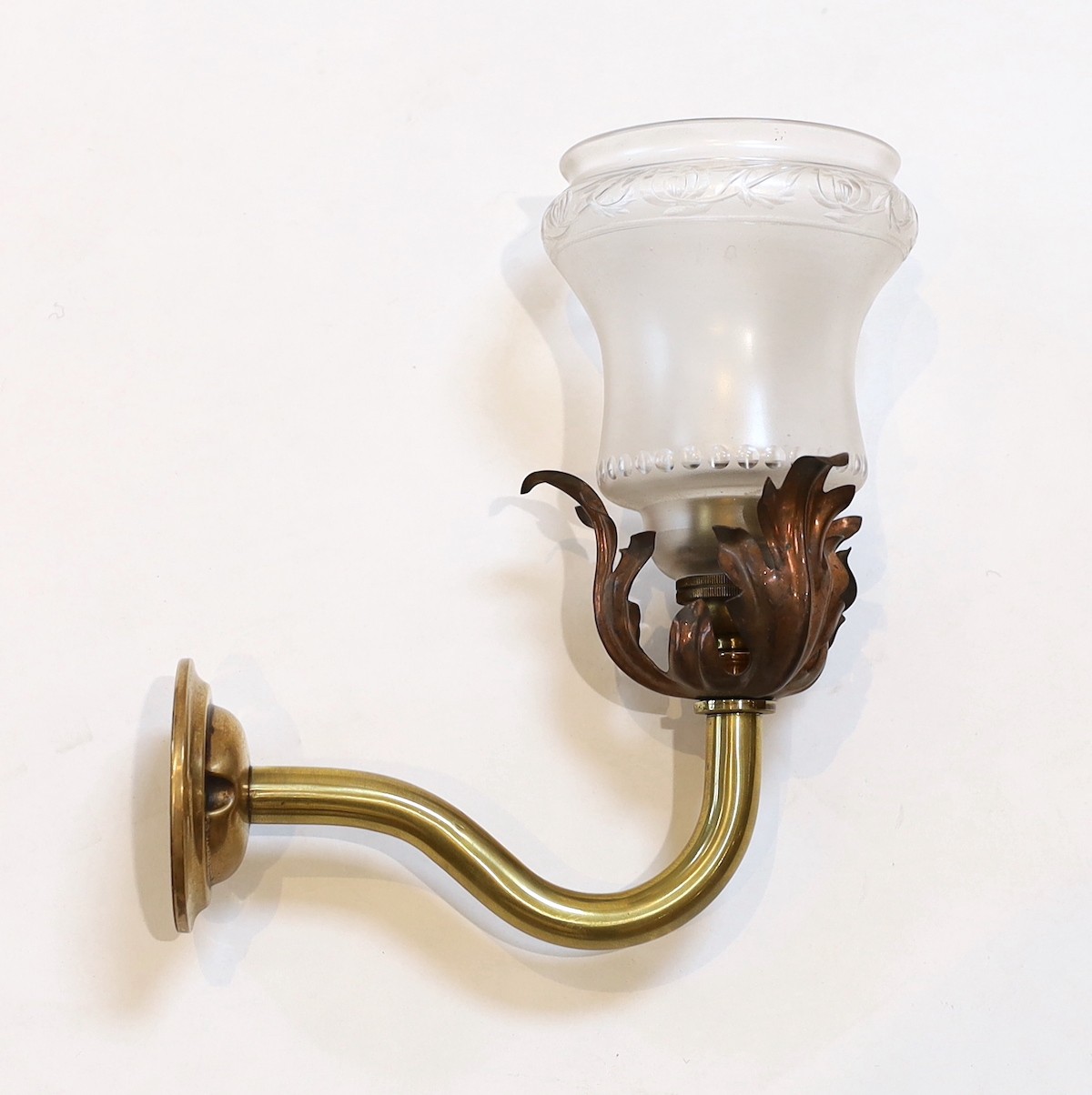 An English Arts & Crafts copper and brass wall light with cut and frosted glass shade, 22cm
